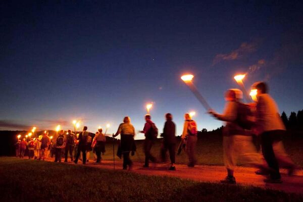 Menschen bei einer Fackelwanderung