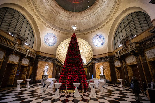 Weihnachtsbaum voller roter Blumen in einem Gebäude