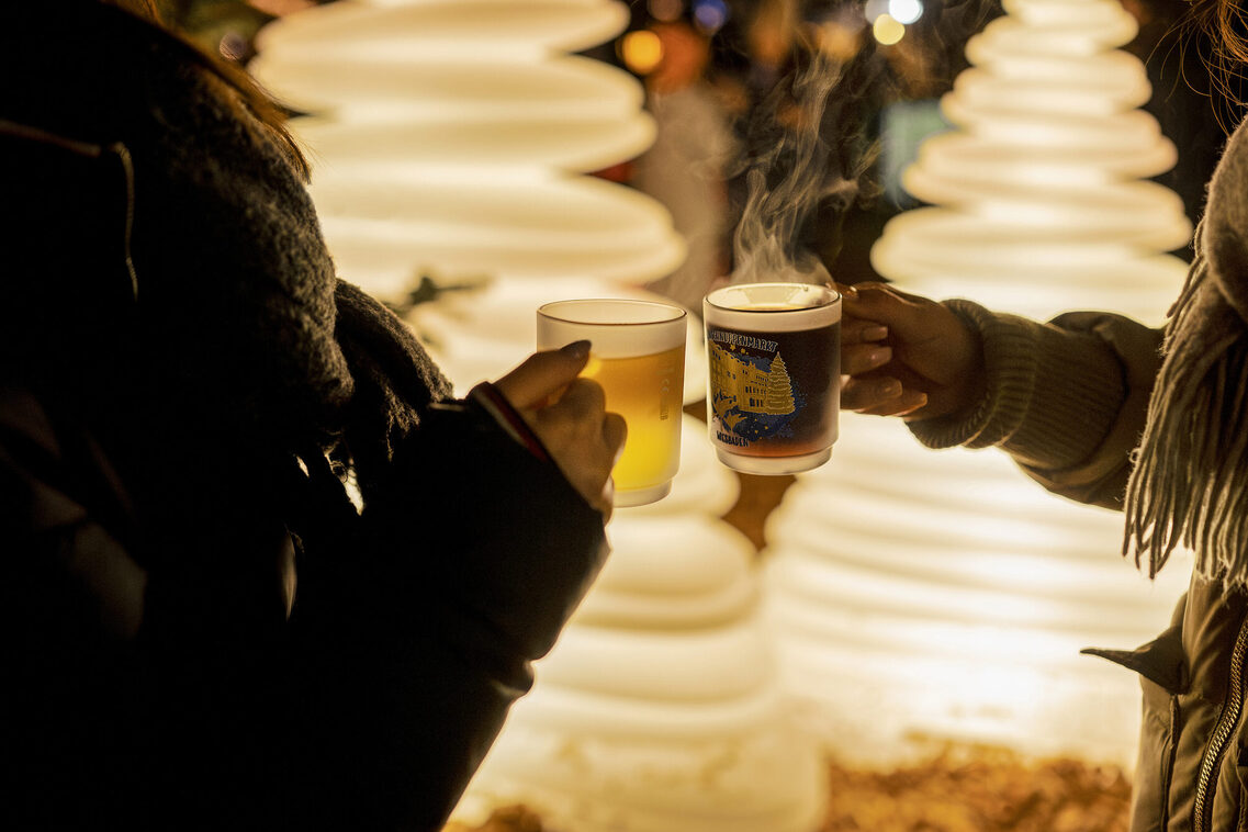 Hände mit Glühweintassen